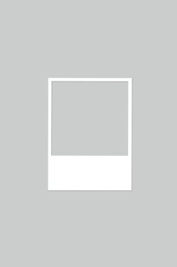 A gray background with a white frame in photo shape with copy space