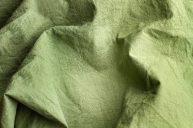 Yakından bakınca kırışık yeşil bir kumaş arkaplan