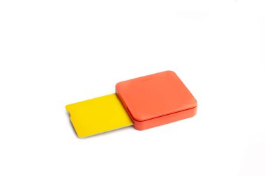 Beyaz arka planda sarı kredi kartı olan bir turuncu kart okuyucusu.