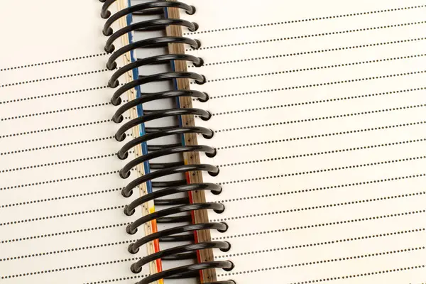 A spiral dotted line notebook in a close up view