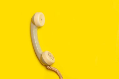 Kopya alanı olan sarı bir arkaplanda klasik telefon ahizesi