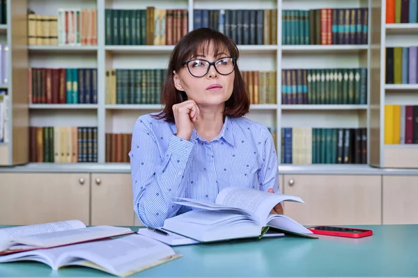 Vrouwelijke Lerares Van Middelbare Leeftijd Werkzaam Bibliotheek Schrijft Kranten Aan — Stockfoto