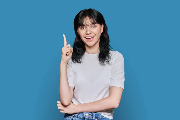 Attractive Happy Young Woman Showing Index Finger Blue Studio Background — Stock Photo, Image