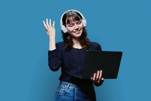 Cheerful Young Female Headphones Looking Laptop Blue Color Studio Background — 图库照片