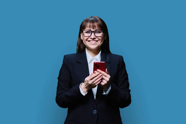 Sorridente Donna Affari Mezza Età Utilizzando Smartphone Sfondo Blu Studio — Foto Stock