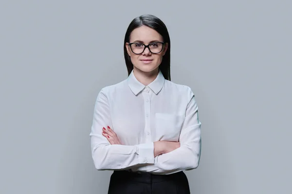Confident Business Young Female Glasses Looking Camera Grey Color Studio — Foto Stock