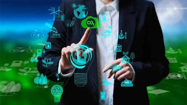 Preservation of ozone layer of planet earth concept. Hands touching CO2 sign on digital screen with symbols of green alternative renewable energy solar geothermal wind energy hydropower biofuel