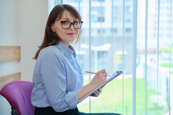 Middle Aged Female Clipboard Sitting Office Window Business Woman Paper — Stock Photo, Image