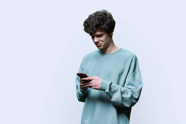Unga Leende Kille College Student Tittar Smartphone Vit Bakgrund Snygg — Stockfoto