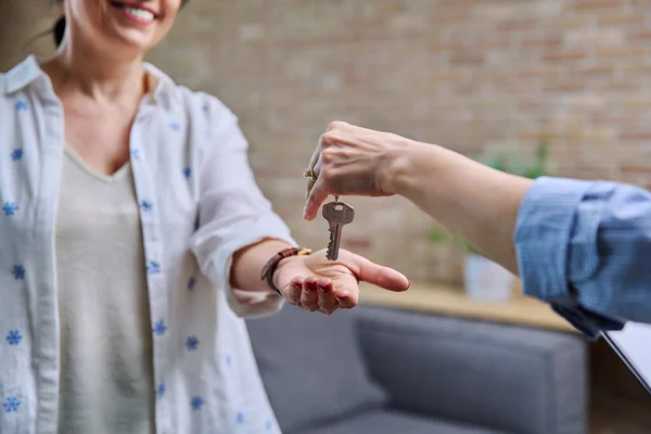 stock image Mature woman buyer real estate tenant taking keys from realtor hands. Successful transaction, sale, rental property