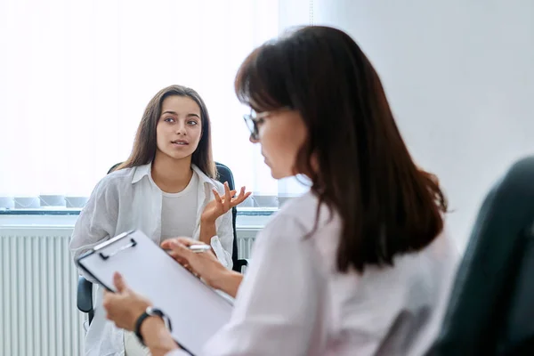 School counselor psychologist talking to teenage student girl. Adolescent social worker, mental health, adolescence, psychology, psychotherapy, mentoring, therapy, professional support