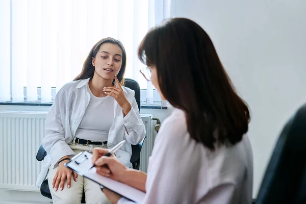 School counselor psychologist talking to teenage student girl. Adolescent social worker, mental health, adolescence, psychology, psychotherapy, mentoring, therapy, professional support