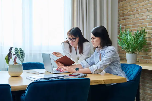 Two Serious Business Women Colleagues Sitting Large Table Office Typing — Stock Photo, Image