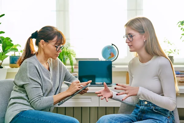 Young teenage girl high school student talking with psychologist, therapist, counsellor, social worker. Mental session therapy, support, psychology, psychotherapy, adolescence, youth concept