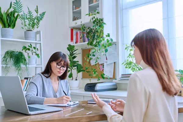 Young woman university college student at meeting with female professional mental therapist, social worker, counselor, behavior. Psychology therapy help counseling treatment support, mental health