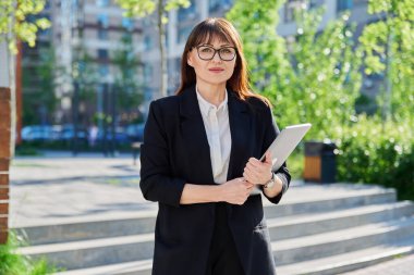 İş portresi, kendinden emin, dışarıda dizüstü bilgisayarı olan, eğitim ofisi geçmişi olan başarılı bir kadın. Ofis çalışanı okul öğretmeni sigorta bankacılık hukuk firması emlakçısı