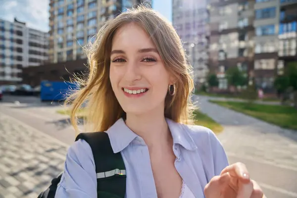 stock image Selfie portrait of young beautiful attractive happy blonde female looking at camera outdoor. Smiling teenage girl student 17, 18 years old. Education youth success happiness lifestyle concept