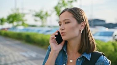 Dışarıda telefonla konuşan genç bir kadın, yüz yüze, şehir tarzı. Teknoloji, iletişim, yaşam tarzı, gençlik kavramı