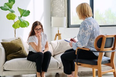 Mutsuz, üzgün, orta yaşlı kadın terapi seansında psikolog, ruh sağlığı muayenehanesinde olgun hastalara destek oluyor. Psikoloji Psikoterapi Psikiyatri Danışmanlık Konsepti