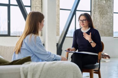 Profesyonel kadın terapist psikolog genç bir kadın hastayla çalışıyor. Psikoloji psikoterapi zihinsel terapi seansı, gençlik öğrencileri için sosyal psikolojik hizmet