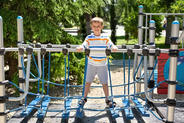 Cheerful Boy Walks Rope Bridge Playground Park — Stock Photo, Image