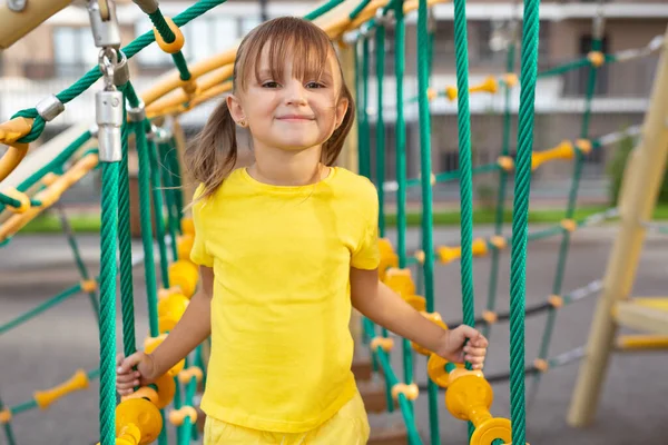 Cheerful Girl Climbs Giant Spider Web Modern Playground — Stock Photo, Image