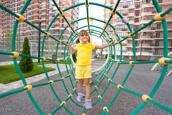 Cheerful Girl Climbs Giant Spider Web Modern Playground — Stock Photo, Image