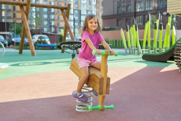 Little Girl Rocking Wooden Rocking Chair Spring Modern Playground — Stock Photo, Image