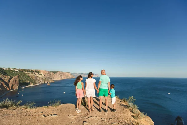 stock image Happy family of four walking in the mountains. Family concept. Family trip