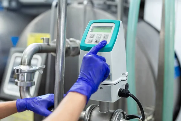 stock image Automated milk production process at the factory. The worker starts the machine