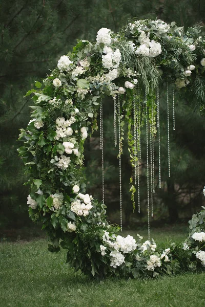 circle wedding arch with flower petals and candles