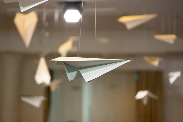 Decor in the restaurant is made of paper planes under the ceiling.
