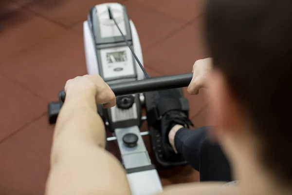 stock image Man running rowing exercise in the gym