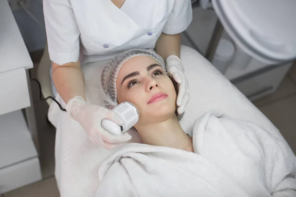 Stock image Cosmetology. Beautiful Woman Receiving Facial Skin Ultrasound Cavitation. Closeup Of Female Face Receiving Anti-Aging Cosmetics Using Ultrasound Cavitation Machine. Body Care