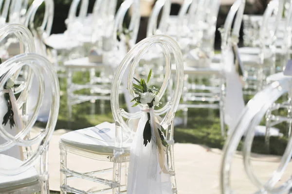 White transparent chairs at the wedding ceremony