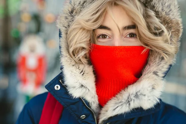 stock image Portrait of a woman in a hood and a red scarf on a frosty day