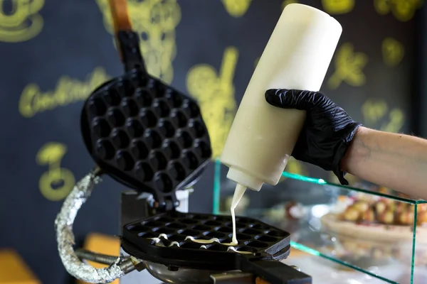 stock image Pouring dough on waffle maker. Preparing Hong Kong waffle