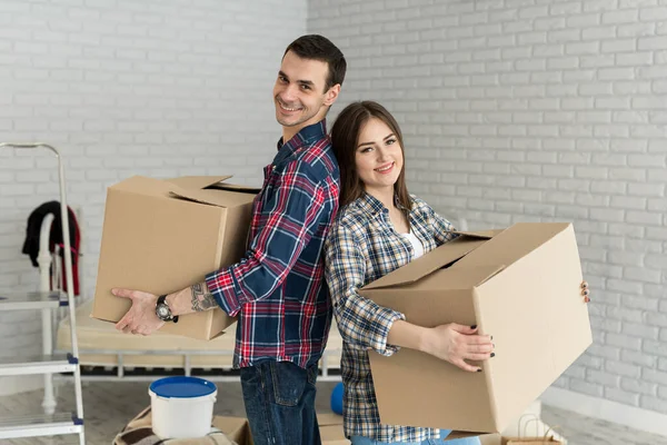 stock image Happy couple is having fun with cardboard boxes in new house at moving day