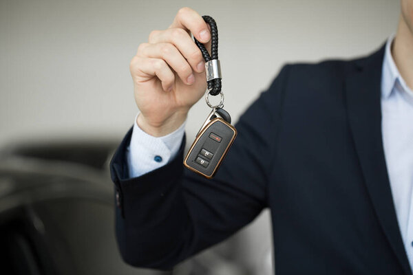Car dealer with key close-up