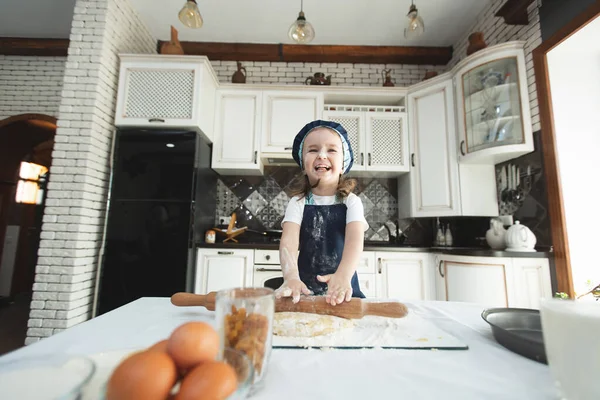 Little Girl Apron Chefs Hat Rolling Out Cookie Dough Laughing — Stock Photo, Image