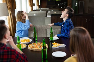 Mutlu arkadaşlar grubu pizza yiyip, hamburger yiyorlar.