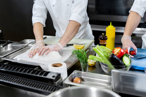 Chefs prepare meals in the kitchen