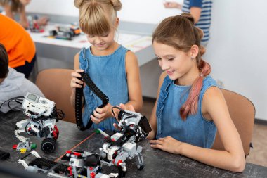 Eğitim, çocuk, teknoloji, bilim ve insan kavramı - grup robotlar robot okul ders bina dizüstü bilgisayar ile mutlu çocuk