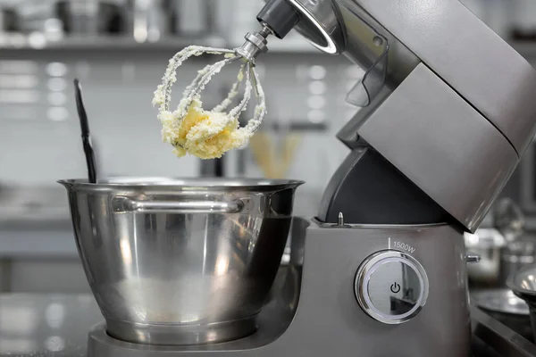 stock image Butter with sugar on the Corolla of the kitchen machine, mixer.