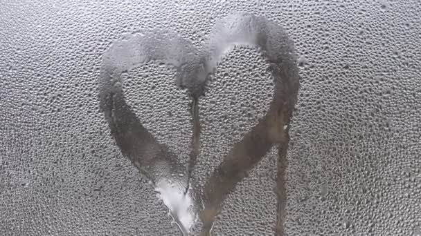 Drawing Heart Sweaty Glass Window Drops Run Glass — Stock Video