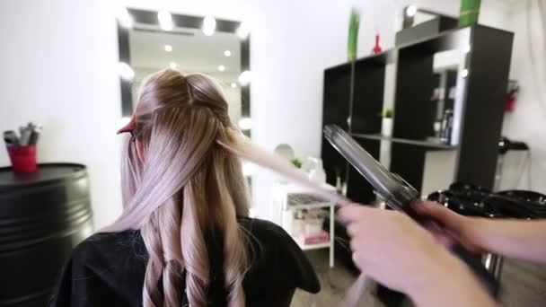 Close Stylists Hand Using Curling Iron Working Woman Client Hair — Stock Video