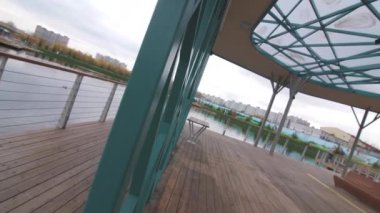 Şehre yakın büyük sakin göl yakınlarındaki boş manzaralı, metal iskeletli, ahşap zemin manzaralı şık bir çardak. Dinlenecek yer