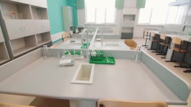 Clean workplace with sink and equipment in empty chemistry classroom closeup. Equipment for students experiments