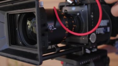 ALMATY, KAZAKHSTAN - JULY 27 2022: Man hands adjust digital video camera before shooting at filming set closeup. Film making equipment and technology on July 27 in Almaty