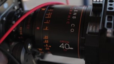 ALMATY, KAZAKHSTAN - JULY 27 2022: Large adjustable lens of professional video camera on blurry background macro view. Digital equipment for footage on July 27 in Almaty